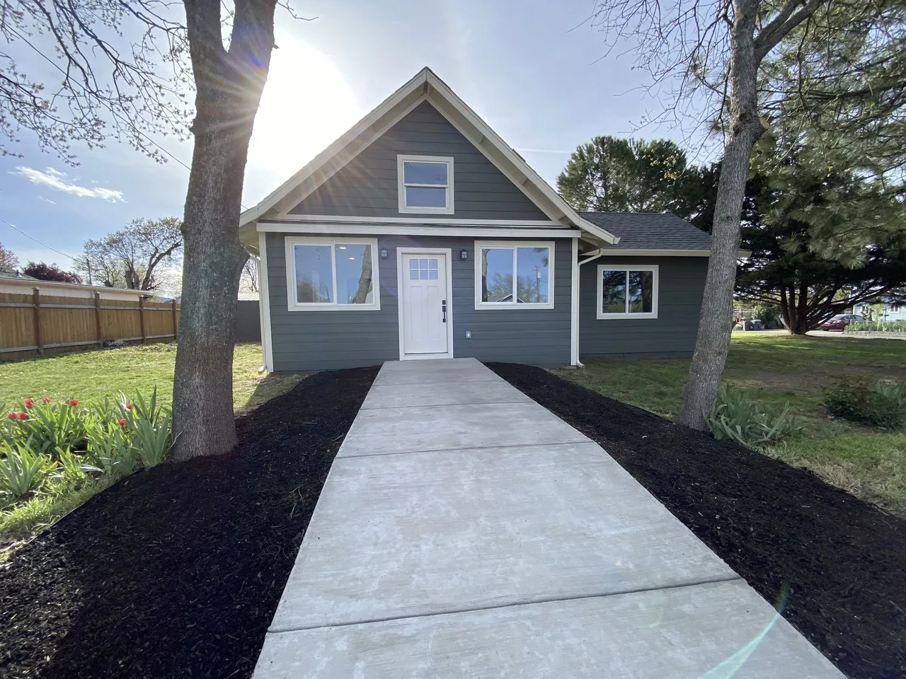 Finished home with dark gray-green lap siding and white trim by Next Gen Contracting in Southern Oregon