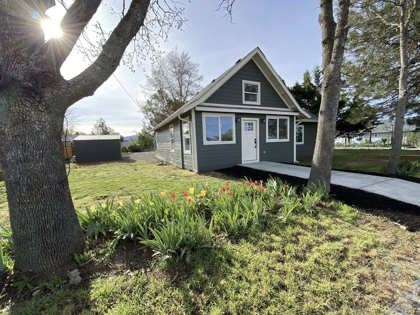 Single-story home with gray-green lap siding and white trim by Next Gen Contracting in Southern Oregon